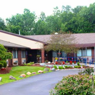 A well-maintained building with a landscaped garden and driveway.
