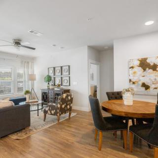 A modern open-plan living room and dining area with stylish furnishings and wood flooring.