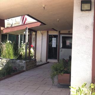 Entrance to a building with plants and pavement.