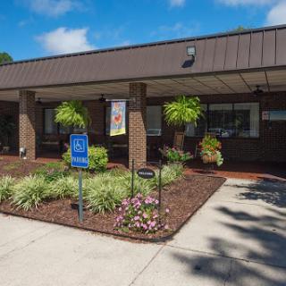 A well-maintained commercial building with accessible parking and landscaped gardens.