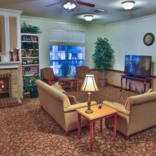 A cozy living room with sofas, a fireplace, and a television.