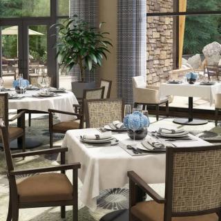 Elegant restaurant interior with neatly arranged tables and chairs.