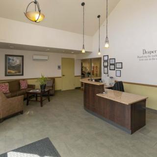 A modern reception area with a desk and waiting seating arrangement.