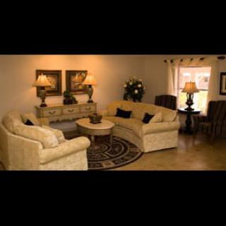 A cozy living room with comfortable sofas, a central coffee table, and elegant decor.