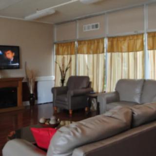 A cozy living room with modern furnishings and a television.