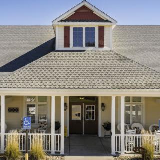 A charming house with a front porch and gabled roof.