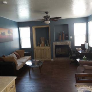 A cozy living room with a sofa, coffee table, and a fireplace.