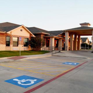 Front view of a building with accessible parking spots.