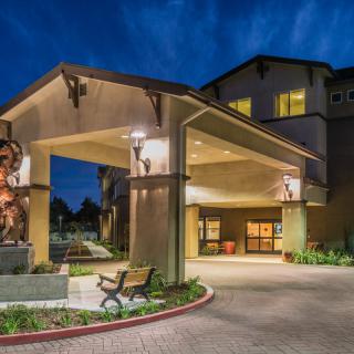 A well-lit hotel entrance at night.