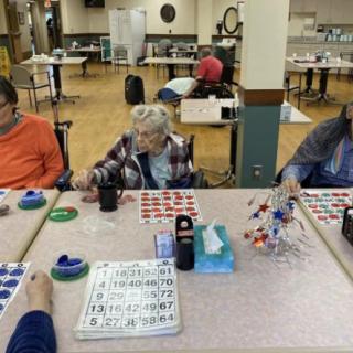 A group of seniors playing bingo at a community center.