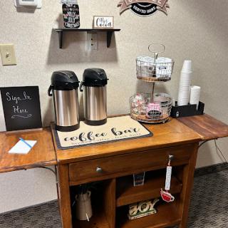 A cozy coffee station set up with beverages and snacks, welcoming guests to relax.