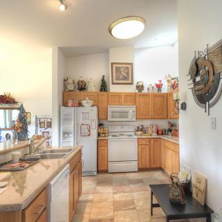 A cozy kitchen with wooden cabinets, white appliances, and decorative elements.
