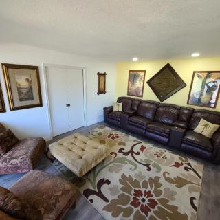 Cozy living room with leather seating and decorative artwork.