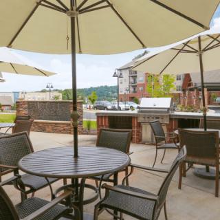 A scenic outdoor patio with tables and chairs under large umbrellas.
