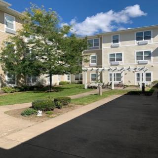 A sunny day at a residential apartment complex with well-maintained landscaping.