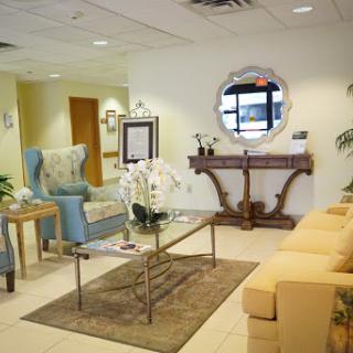 A stylish and inviting waiting room featuring comfortable furniture and elegant decor.