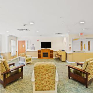 A bright and welcoming lobby area with comfortable seating and a television.