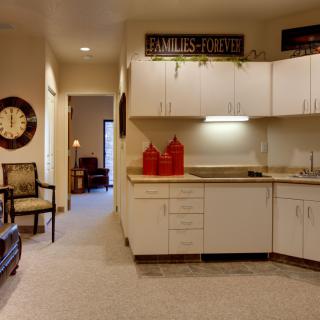 A cozy modern kitchen interior with white cabinets and decorative elements.