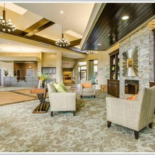 A spacious and elegantly designed lobby with modern furniture and decorative elements.