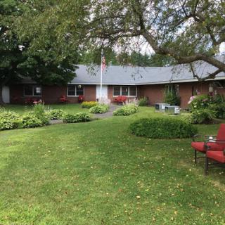 A peaceful home with a well-maintained garden and outdoor seating area.