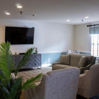 A cozy living room with comfortable seating and a large TV.