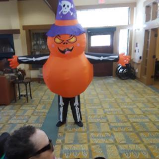 A cheerful inflatable Halloween decoration in the shape of a pumpkin with a pirate hat, adding festive spirit to the room.