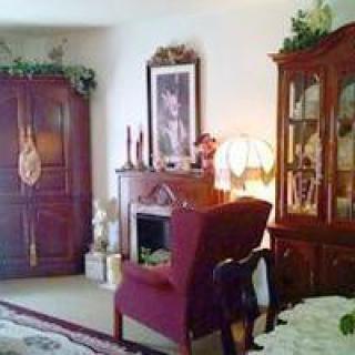 A cozy, traditionally-styled living room with warm lighting and elegant furniture.