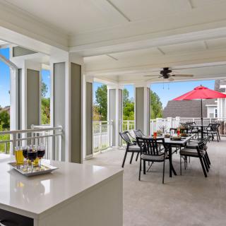 A modern outdoor patio with stylish furniture and a scenic view.