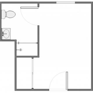 A simple floor plan featuring a bathroom layout with a toilet and sink, alongside an open space area.