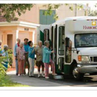 A group of senior citizens boarding a community bus.