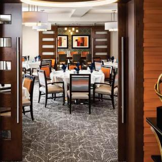 A modern restaurant dining area with neatly arranged tables and stylish decor.