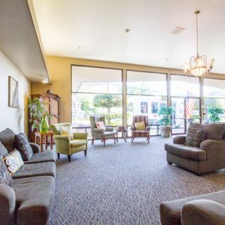 A bright and spacious living room with comfortable seating and large windows.