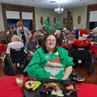 Seniors enjoying a festive holiday meal together in a cozy indoor setting.