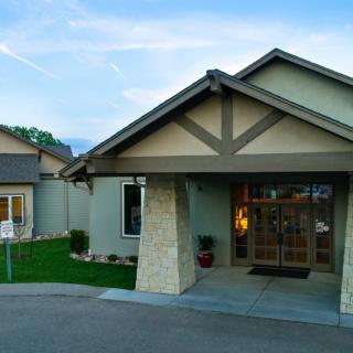 Front view of a modern residential house with a landscaped yard.