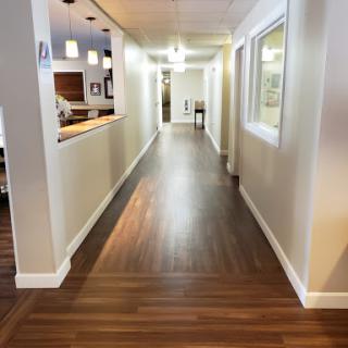 A well-lit hallway showcasing modern design with wooden flooring.
