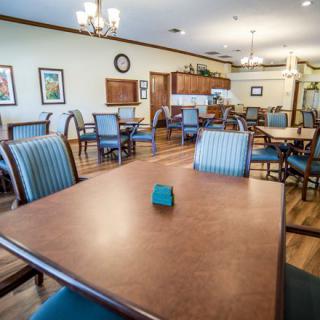 A well-furnished dining area with neatly arranged tables and chairs.