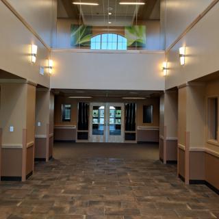 A well-lit hallway with modern architecture leading to an entrance.
