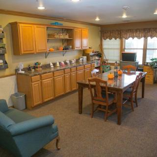 A cozy living space featuring a dining table, wooden cabinets, and comfortable seating.