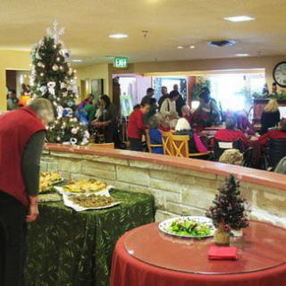 A festive holiday gathering with Christmas decorations and a buffet table.