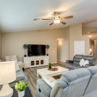 Modern living room with comfortable seating and a large TV.