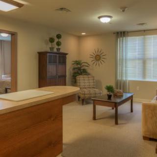 A cozy office reception area with comfortable seating and decorative elements.