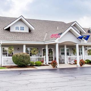 A residential-style building with flags on a cloudy day.