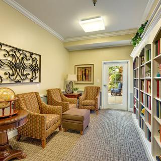 A cozy reading room with armchairs and bookshelves.