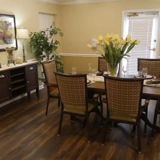 A cozy dining room set with a table, chairs, and elegant decor.