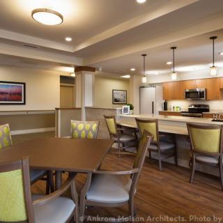 A modern kitchen and dining area with contemporary lighting and furniture.