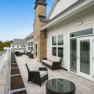 A modern outdoor patio with comfortable seating and stylish architecture.