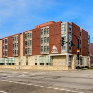 A modern brick building located at a city street intersection.