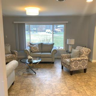 A cozy living room with comfortable seating and a large window view.