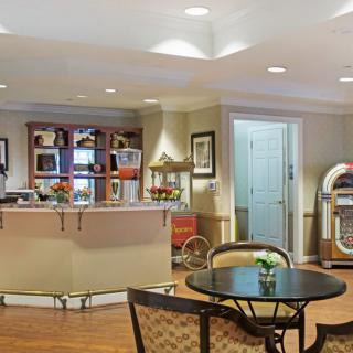 A cozy lounge area with a reception desk and jukebox.