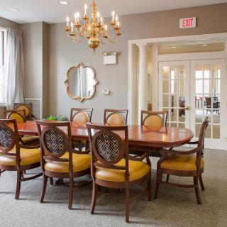 Elegant dining room with a chandelier and classic furniture.